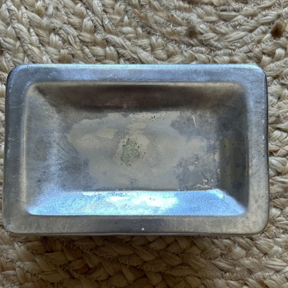decorative silver-tone pedestal dish, likely used as a soap dish, trinket holder